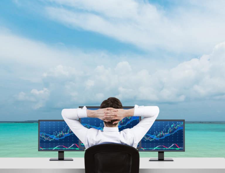 person sitting infront of trading setup